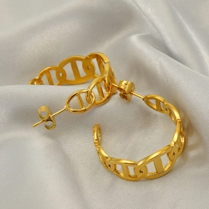 Elegant gold-tone stainless steel hollow hoop earrings on a luxury silver silk fabric