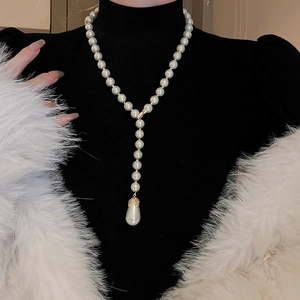 French vintage double layer necklace with white teardrop pearl and gold details on model