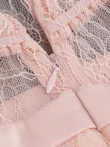 Detail of pink lace evening dress with invisible back zipper and satin waist ribbon