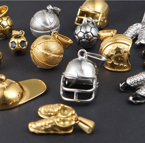 Detailed macro view of gold and silver sports pendants on a sleek black background