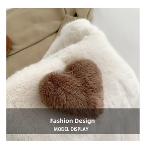 Close-up of fluffy cream plush material with a brown heart-shaped fuzzy patch detail