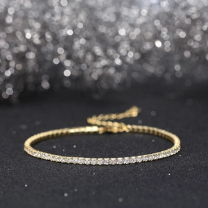 Detail shot of 2MM gold plated tennis bracelet with sparkling round-cut cubic zirconia