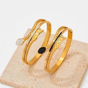Snake shaped gold-plated stainless steel bracelet with sparkling rhinestone inlay details