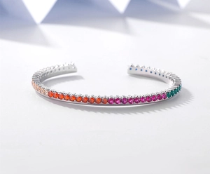 Macro shot of silver open cuff bracelet with rainbow gradient zircon stones