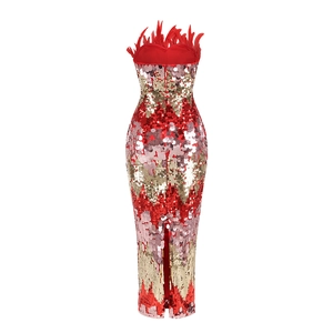 Detail of red sequined evening gown featuring a feather trim and back zipper closure