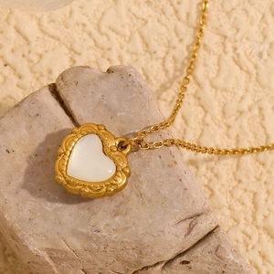 Vintage 18K gold plated heart necklace with mother of pearl inlay on a natural stone