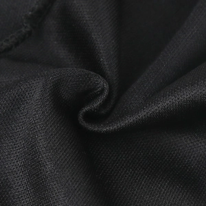 Detailed macro view of the breathable black mesh fabric and elastic knit texture