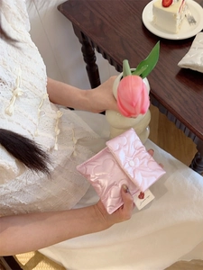Pink quilted heart pattern sanitary storage bag with white button closure for women