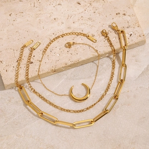 Close-up of 18K gold plated stainless steel crescent and paperclip chain bracelet set