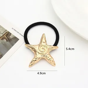 Detailed view of a gold starfish hair tie with dimensions 4.9cm by 5.4cm and weight 9g
