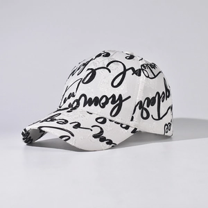 Detailed macro view of the white baseball cap with intricate lace texture and black script art