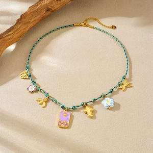 Bohemian braided cord necklace with gold charms including butterfly, bee and cross pendants