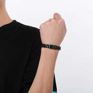 Detailed close-up of 12mm black matte Cuban link bracelet worn on a male wrist