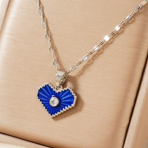 Blue pixelated heart pendant necklace with sunburst texture and diamond in a gift box