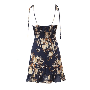 Navy floral print dress with ruffle hem, smocked back, and adjustable tie shoulder straps