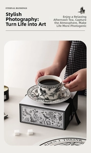 Detail of floral ceramic coffee cup and saucer set with a vintage illustrated gift box