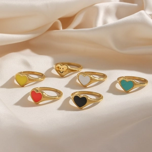 Group of 18k gold plated stainless steel heart rings with colorful enamel on silk