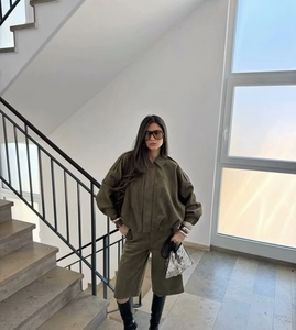 Detail view of army green velvet loose jacket and mid-waist bermuda shorts for women