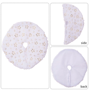 Detail of white plush Christmas tree skirt with golden star sequins and texture