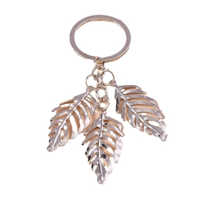 Creative silver alloy hollow leaf keychain with three leaf pendants on white background