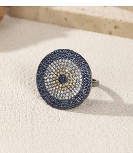Detailed macro shot of an S925 silver evil eye ring with blue and white zircon pavé