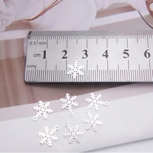 S925 sterling silver snowflake charm pendants shown with ruler for size reference