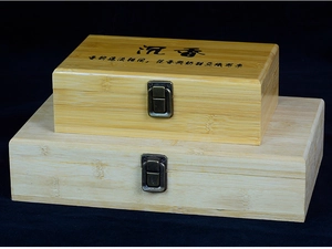 Detail of stacked bamboo gift boxes with vintage metal buckles and engraved calligraphy