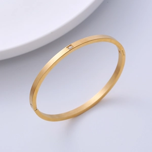 Minimalist 18K gold plated stainless steel bangle with a single square zircon stone