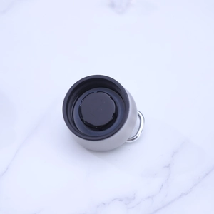 Detail view of the 304 stainless steel lid with a black seal and metal hanging ring