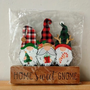 Detailed view of three 3D wooden Christmas gnomes on a HOME Sweet GNOME wooden stand