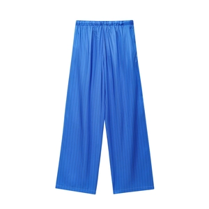 Detailed view of blue striped wide-leg trousers with satin texture and elastic waistband