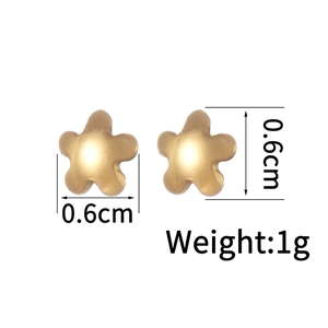 Detail showing 18K gold plated star stud earrings with 0.6cm dimensions and 1g weight