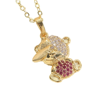 Golden bear pendant necklace with red zircon inlay on clean white background