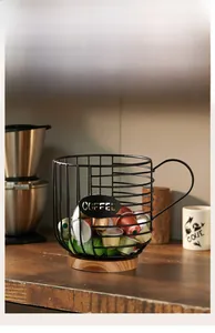 Detail of coffee capsule holder basket with metal wire frame, wooden base and COFFEE logo