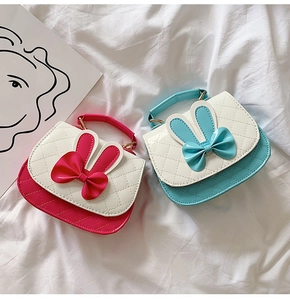 Detail of pink and blue girls' quilted faux leather bags with cute bunny ears and bows