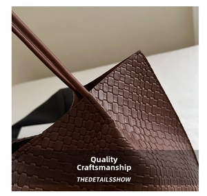 Close-up of brown hand-woven leather texture and stitching detail on tote handbag