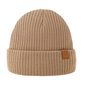 Detailed view of the khaki ribbed knit winter hat with brown leather logo patch tag
