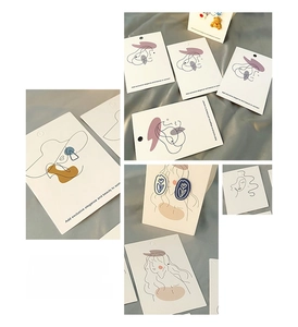 Detail of minimalist line art display cards for DIY jewelry with elegant silk background
