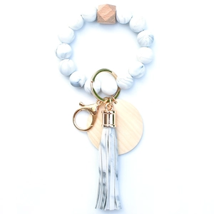 Detail of marble pattern silicone beads with hexagonal wood bead and gold keyring