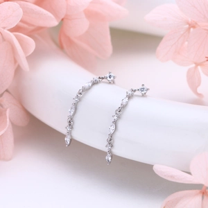 Macro detail of S925 sterling silver chain earrings with brilliant marquise cut cubic zirconia