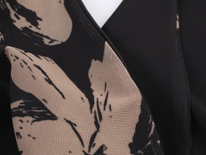 Detailed macro view of beige floral mesh print fabric on a black sleeveless dress