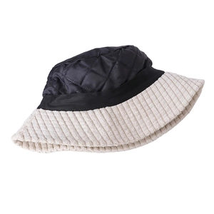 Detail of quilted nylon crown and corduroy brim textures on a bucket hat