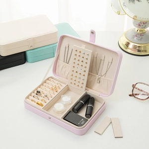 Portable PU leather jewelry box with multiple compartments in pink, white, mint, and black