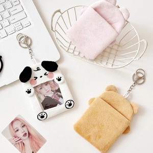 Plush animal-shaped card and earphone cases displayed in a clean minimalist lifestyle setting