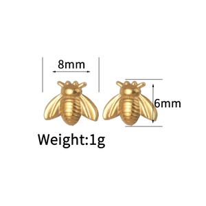 Detailed view of gold bee stud earrings with 8mm width and 6mm height dimensions
