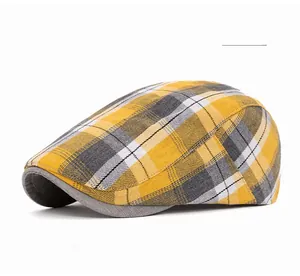 Close-up of yellow plaid newsboy cap showing breathable eyelets and fabric texture