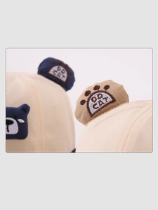 Detailed view of baby sun hat with cute bear embroidery and 3D round ear accents