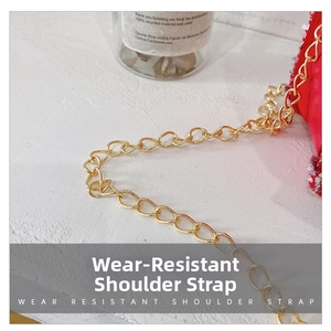 Detail shot of durable gold metal chain strap on a red woven little girl handbag