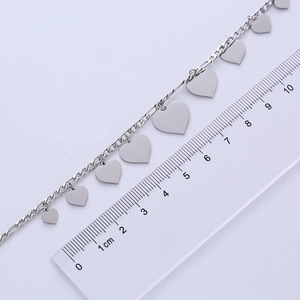 Close-up of silver heart-shaped pendant necklace with measuring scale for size reference
