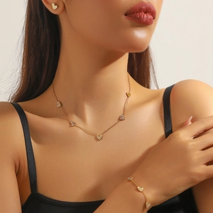 Gold plated stainless steel jewelry set with white heart charms and pearl details